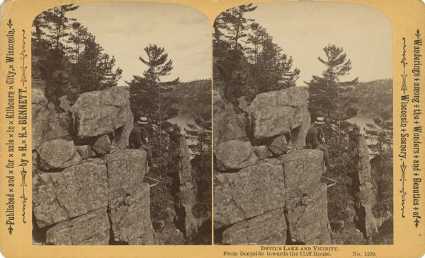 Stereograph of a man sitting on a cliff. Text at right: "Wanderings Among the Wonders and Beauties of Wisconsin Scenery."