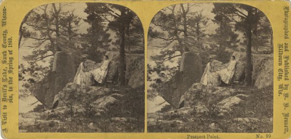 Two girls in long dresses on a rock formation. The river and far shoreline is in the background. Text on left reads: "A Visit to Devil's Lake, Sauk County, Wisconsin, in the Spring of 1869."