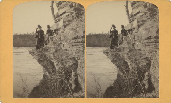 Evaline Helen Marshall and unidentified woman on a rock cliff over Devil's Lake.
