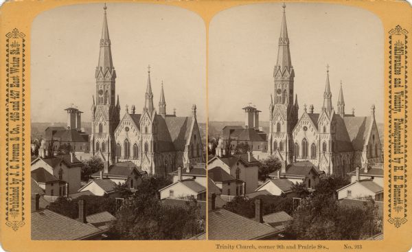 Elevated stereograph of the Trinity Church, surrounded by the rooftops of nearby homes. Text at right: "Milwaukee and Vicinity, Photographed by H.H. Bennett."