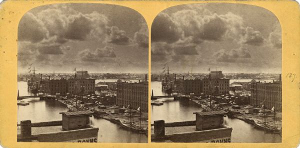 Elevated view of boats and sailing ships along port.