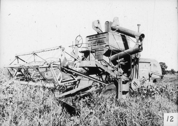 A John Deere harvesting combine in a field.
