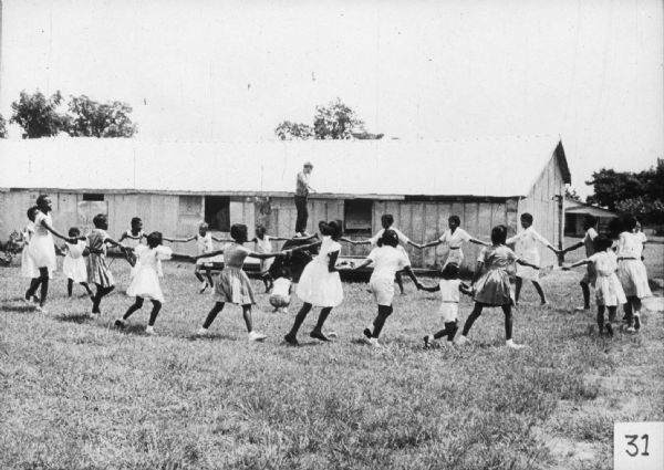 Children play a game outdoors as a part of a Freedom School activity.