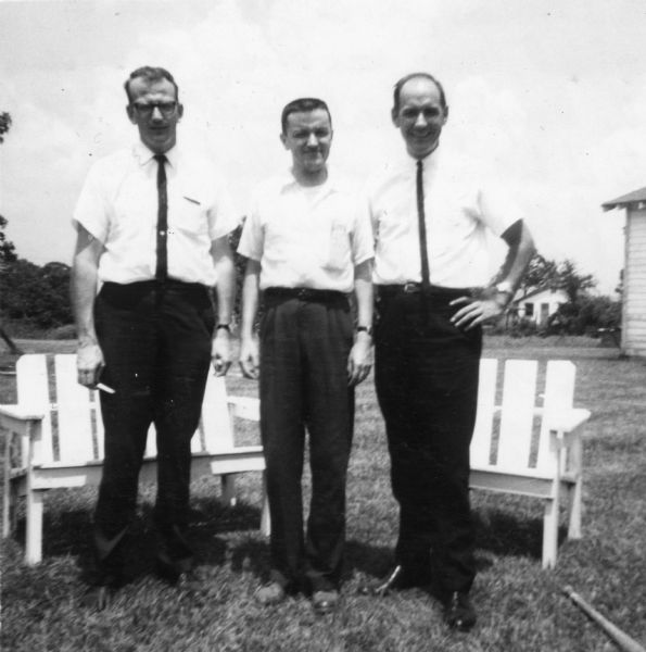 Group portrait of three ministers taken by a civil rights volunteer. "Ned Gillam, Disciple of Christ minister, Fairfield, Iowa, was denied admittance to the Disciple of Christ church in McComb after it became known that he was working for the Delta Ministry. Known members of the Ku Klux Klan belonged to this church. The other two ministers were quietly active in trying to bring white businessmen, clergy, etc., into a dialogue of concern in McComb. These two men also visited Natchez a few days in order to ascertain what value the Delta Ministry could have. Their report was a negative one since Negroes of Natchez were at that time not working together."