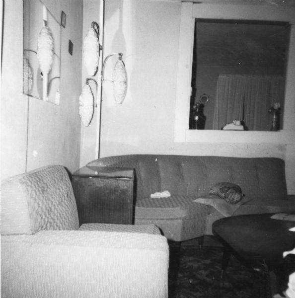 Interior of a home taken by a civil rights volunteer.  "The living room at the Thompson's. Actually, the room was somewhat misleading since the other rooms were quite unlike this one and in need of repair. My bedroom, for example, leaked in three different places during rain. The hospitality, the kindness, and concern which the Thompsons showed toward me, however, meant more to me than the more comfortable quarters in Hattiesburg."