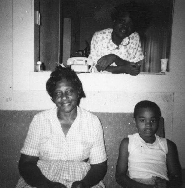 A woman and two children pose for a photograph taken by a civil rights volunteer. "Mrs. Willie Thompson, my warmly gracious hostess for over two weeks. Usually I would eat breakfast at the house and return about 9:30 p.m. Mrs. Thompson, her husband, or one of her children would then talk with me."