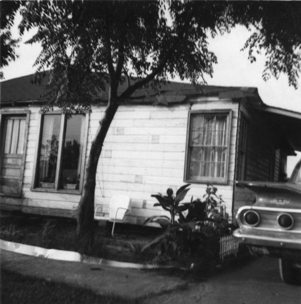 View of a home taken by a civil rights volunteer.  "Mrs. Quin's home.  The section to the right of the tree shows the new bedroom, rebuilt after it was bombed last summer."