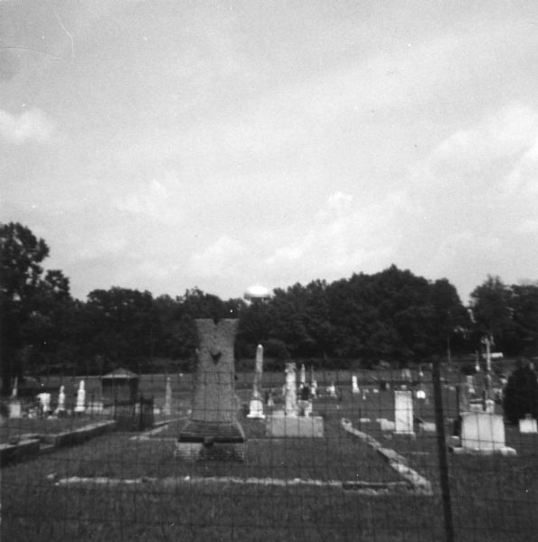 A grave in a segregated cemetery photographed by a civil rights volunteer, who notes that the Caucasian cemetery uses town funding while the African-American cemetery receives none.<p>"This white cemetery in Summit is cared for by paid town workers. Symbolically, one day we talked with a Negro who was digging a grave. On the tombstone was the name 'Barnett'! Even in death, racism can be found in McComb and Summit. The white cemeteries are well kept and are paid for through town taxes."