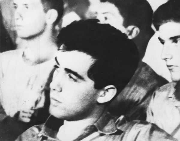 Andrew Goodman seated in a group of people. Andrew Goodman was a civil rights activist and volunteer for the Freedom Summer project. He, along with James Chaney and Michael Schwerner, was murdered in the summer of 1964.