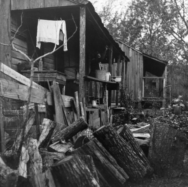 "The 69 year-old woman on the front porch lives alone at the bottom of this unpaved, unlighted, ungraded alley. The building next to her is empty.  She heats with wood. Her toilet is 30 yards behind her house over a rough trail."<p>The Golds Alley neighborhood houses 16 families, 41 people, in 13 buildings. The majority of homes have no indoor plumbing, and the entire neighborhood shares 12 outhouses.