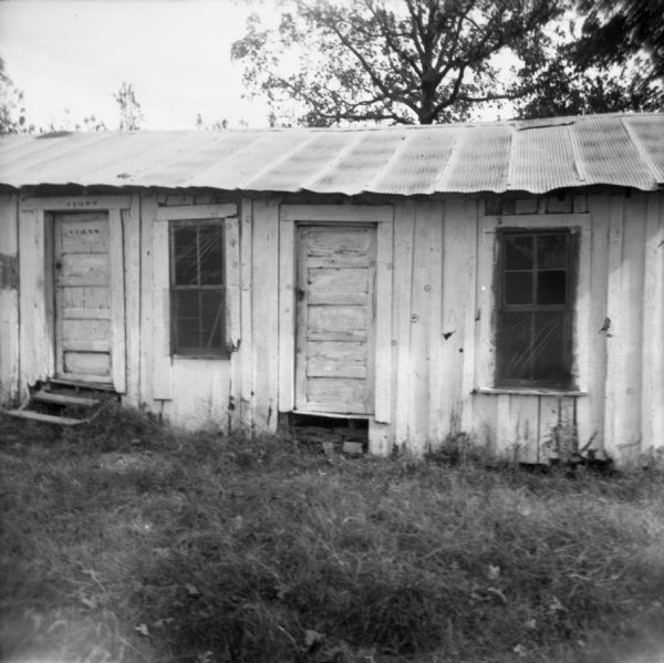 Front view of the Pheba Freedom House, used by civil rights workers. Along the walls and doors, bullet holes have been highlighted with circles.