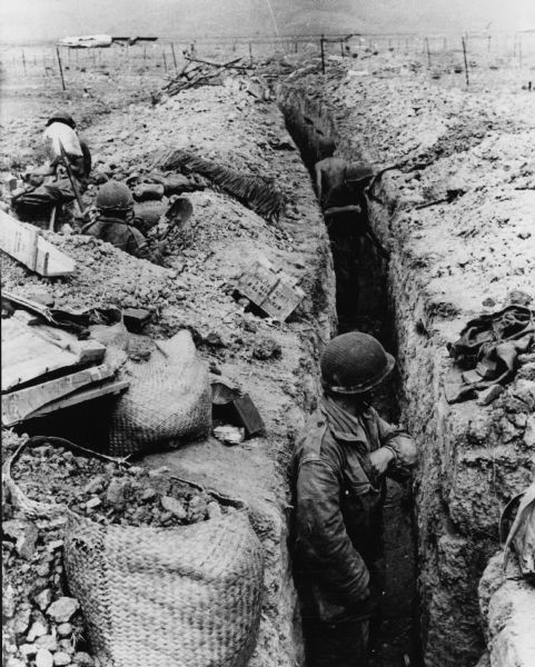 Note on the back: "Defenders dig in. Dien Bien Phu, Indochina: An airport once covered this area where soldiers have dug deep trenches as protection from bombing in the Dien Bien Phu area. As the battle mounted in intensity, French officials reported that air and ground attacks have inflicted heavy losses on the Communists attacking the beleagured fortress. They report the Reds suffered "appreciable losses" when French bombers launched their biggest fire-bomb assault of the war."
