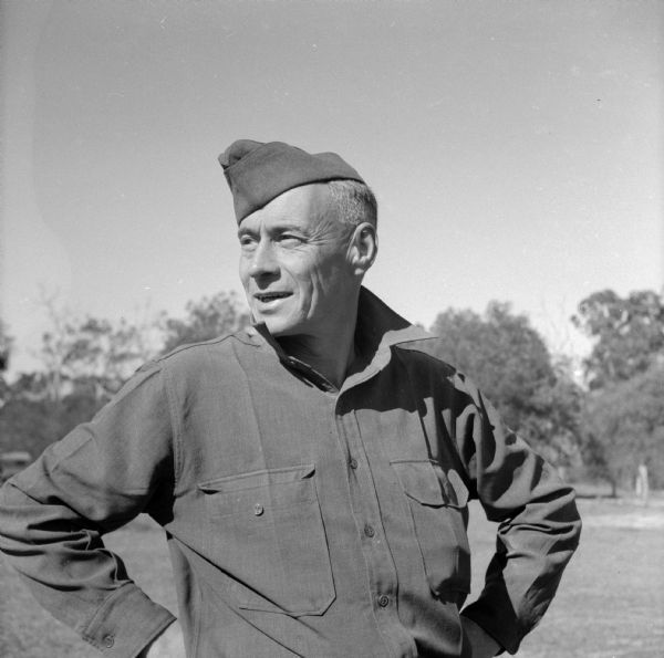 Master Sergeant William (Hub) Gilligan of Camp Douglas, Wisconsin, poses for a photo at Camp Cable, near Brisbane, Australia. Gilligan is a chief clerk of a Red Arrow quartermaster unit. He also served in World War I.