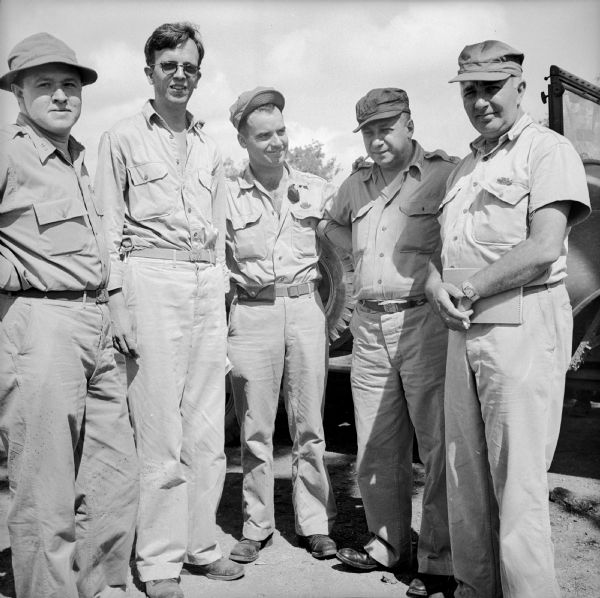 Group portrait of war correspondents at Port Moresby, New Guinea (present day Papua New Guinea). Robert Doyle is in the center.