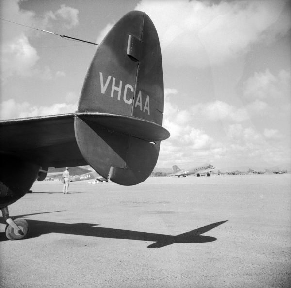 Tail of a Lodestar aircraft at Townsville Airfield, Queensland, Australia. The Lockheed Model 18 Lodestar was a passenger transport aircraft of the World War II-era. The caption written for the newspaper by Robert Doyle reads, "This is one of my favorite snapshots. It was made at one of the busiest-and hottest-airfields in Australia-en route to New Guinea" (present day Papua New Guinea).