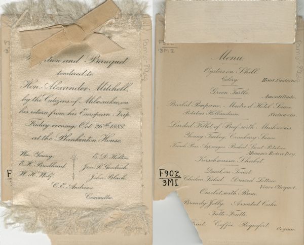 Menu for a reception and banquet for "Hon. Alexander Mitchell by the Citizens of Milwaukee on his return from his European Trip." At the top is a silk ribbon overlay affixed to a card menu with a silk bow.
