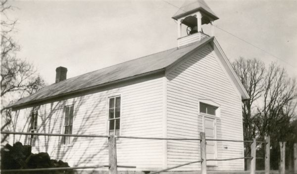 A bell tower stands atop the one-story, clapboard sided Dyer School, District No. 1.