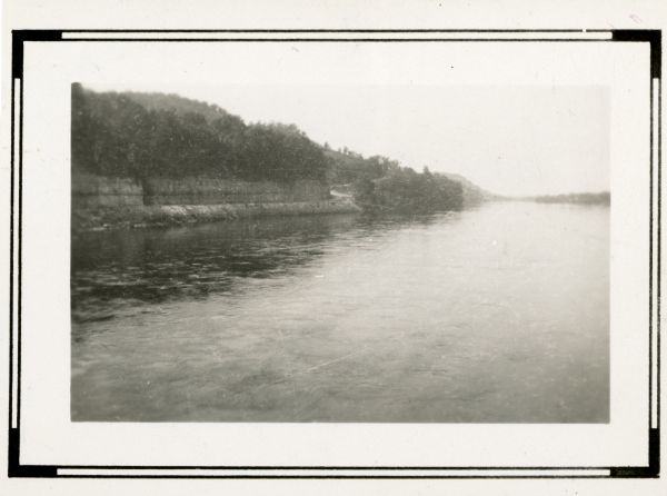 A view, looking west, from the bridge over the Wisconsin River at Lone Rock. A ledge has been cut into the bluff on the left to accommodate County Highway I, now State Highway 133.