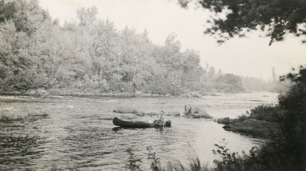 An unidentified man canoes the rapids on the Flambeau River in the northern part of Rusk County, about 12 miles from Ladysmith.