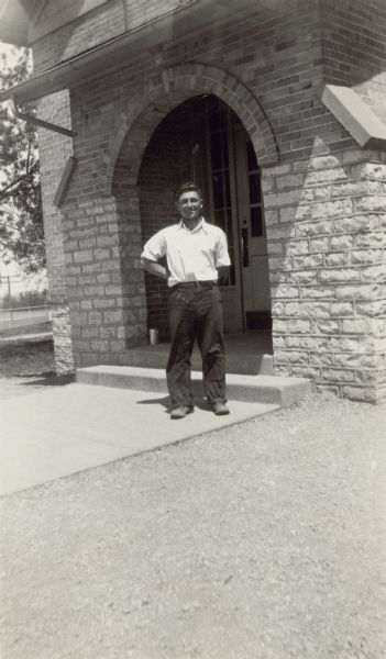 Felix Liburdi, 17 years old, poses in front of the arched front porch of the Hillcrest School, District No. 6, Towns of Waukesha, Pewaukee, Brookfield and New Berlin. The son of Italian immigrants Petro and Annie Liburdi, Felix is identified as the "Leader of highest class in history."