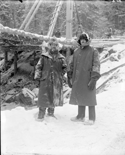 Portrait of (left to right): Lieutenant Colonel R.G.S. Stokes, Corps of Royal Engineers; and Lieutenant Colonel P.S. Morris, Commanding Officer, U.S. Army Corps of Engineers, making an inspection at the construction site of a timber bridge.
