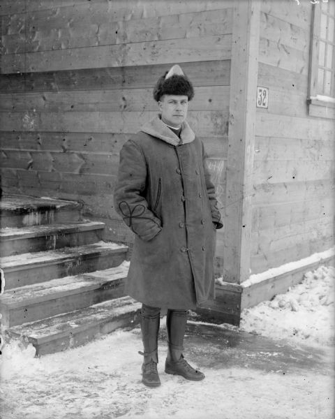 Outdoor portrait of Lieutenant A.W. Baumgarten from Company B, of the 310th U.S. Army Engineer Corps while he was deployed to Archangel [Archangelsk], Russia.
