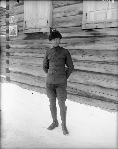 Outdoor full-length ortrait of Lieutenant Burns from Company A, of the 310th United States Army Engineer Corps, standing outside the Headquarters of the 310th Army Engineer Corps in uniform.
