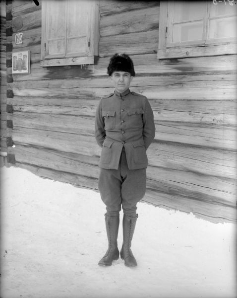 Outdoor full-length portrait of Lieutenant McCurdy from Company A, of the 310th United States Army Engineer Corps, standing outside the Headquarters of the 310th Army Engineer Corps in uniform.
