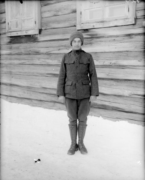 Outdoor full-length portrait of Lieutenant De La Hunt from Company B, of the 310th United States Army Engineer Corps, standing outside the Headquarters of the 310th Army Engineer Corps in uniform.