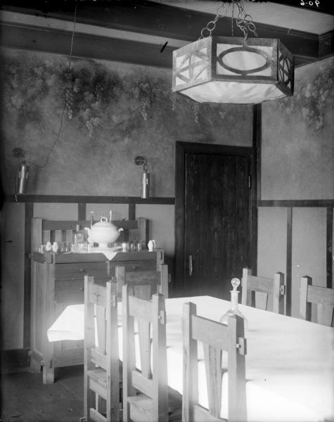 Officers quarters of the 310th U.S. Army Engineer Corps while he was deployed to Archangel (Arkhangelsk), Russia. This room appears to be the dining room, and includes chairs, tables, and a chandelier.