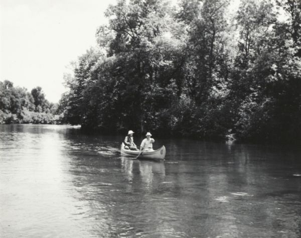 Two men in a canoe on the Namekagon River in northwestern Wisconsin.
