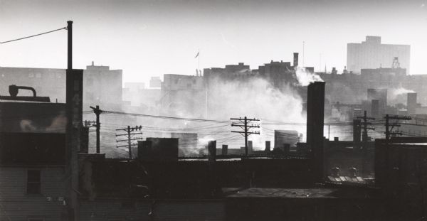 Elevated view over rooftops, looking southwest from North 4th and West Cherry Streets toward the central YMCA building.