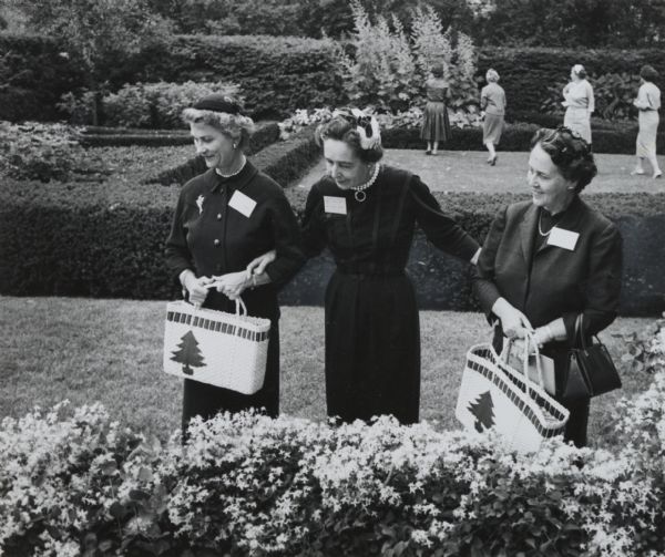Group of ladies inspecting the gardens at the Harry Stratton residence.