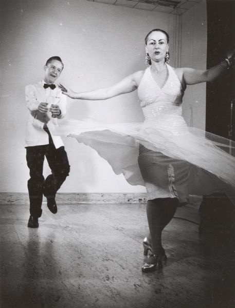 Mrs. Kondrad, a dancer, and her son, dancing in a studio.