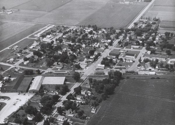 Aerial view of residential homes, farmland and streets.