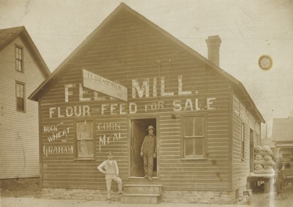 Fred Brendemuehl and Emil Lubich in front of Brendemuehl's feed mill.