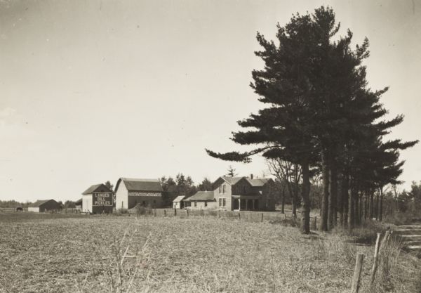 View across field of James Rork farmhouse and farm buildings.