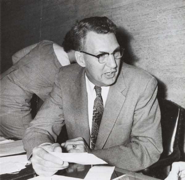 Walter J. Keller, vice-president of the Marine National Exchange Bank, at a desk at the bank.