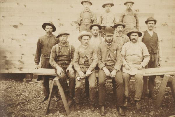 Ed McDill's sawmill crew. Left to right: George Dickerman, George Norton, Charles Norton, Jesse Dickerman and, in a derby, Ed McDill, the owner. The boys and the rest of the men are unidentified.