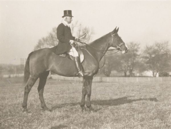 Edward Ilsley of Milwaukee mounted on a horse and dressed for fox-hunting.
