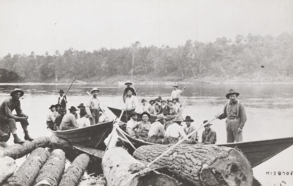 Men in bateaux for the Chippewa Lumber and Boom Company's log drive on the Chippewa River at Jim Falls.