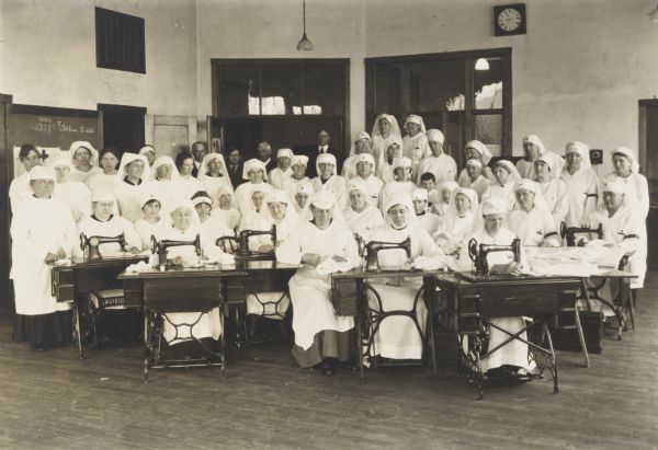 Women of the Dunn County Chapter of the American Red Cross posed with sewing machines in the Stout Institute Building.