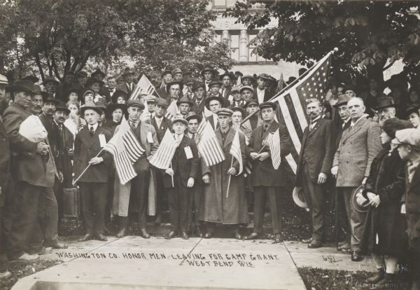 Group of men from Washington County posed with flags leaving for Camp Grant and Army training for service in the first World War.