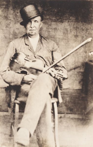 Informal portrait of a “famous Ohio fiddler” Alfred Squiers Utley with his fiddle. Alfred Squiers Utley was born in Monson, Mass. 1817, son of Hamilton and Polly Squires Utley, and died in Newberry, Ohio, 1896.