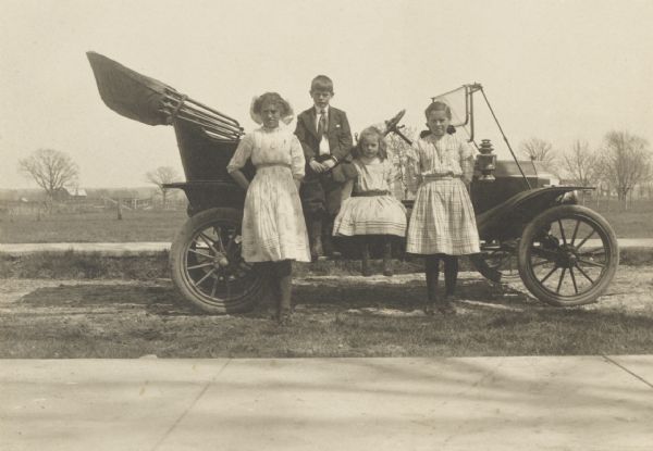 Children of William A. Titus posed at the family model T Ford automobile, the first such car purchased in Fond du Lac County.