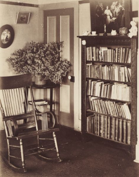 Interior corner, with bookcase and rocking chair, at the Hillside Home School, operated by Misses Ellen and Jane Lloyd Jones.