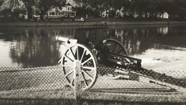 Field artillery piece of the First World War pointing across the Rock River from the grounds of the American Legion post.