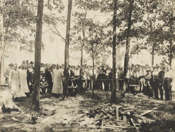 Posed outdoor group portrait, with cooks, at a policemen's picnic or barbecue.