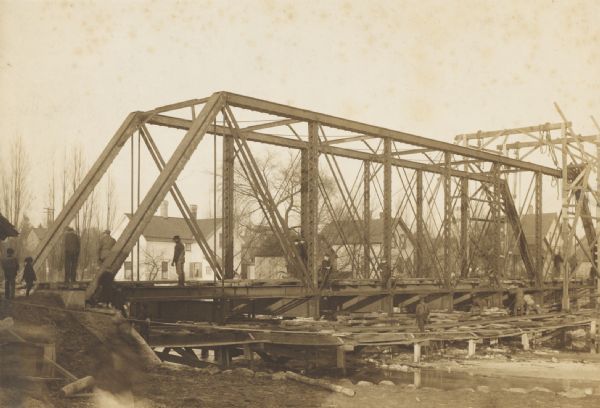 Steel span railroad bridge under construction over Cedar Creek.