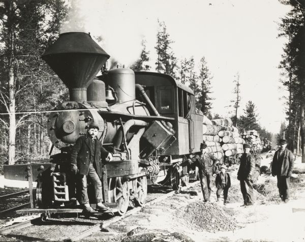 Train-load of logs with wood-burning Heisher geared locomotive and train crew.
